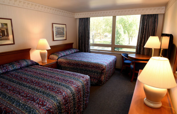 King room with two queen sized beds, desk and a window